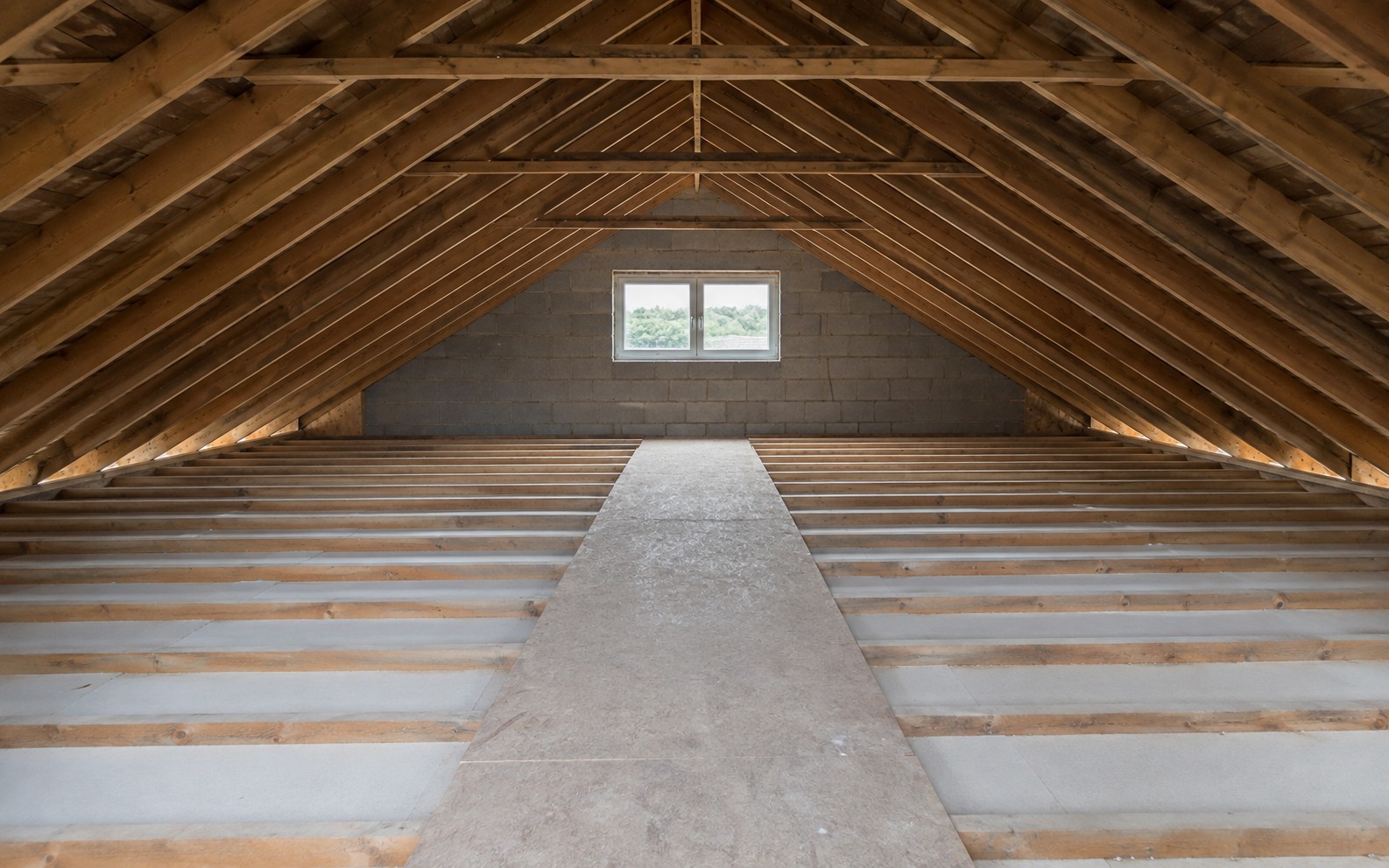 A loft with bare joists and no insulation