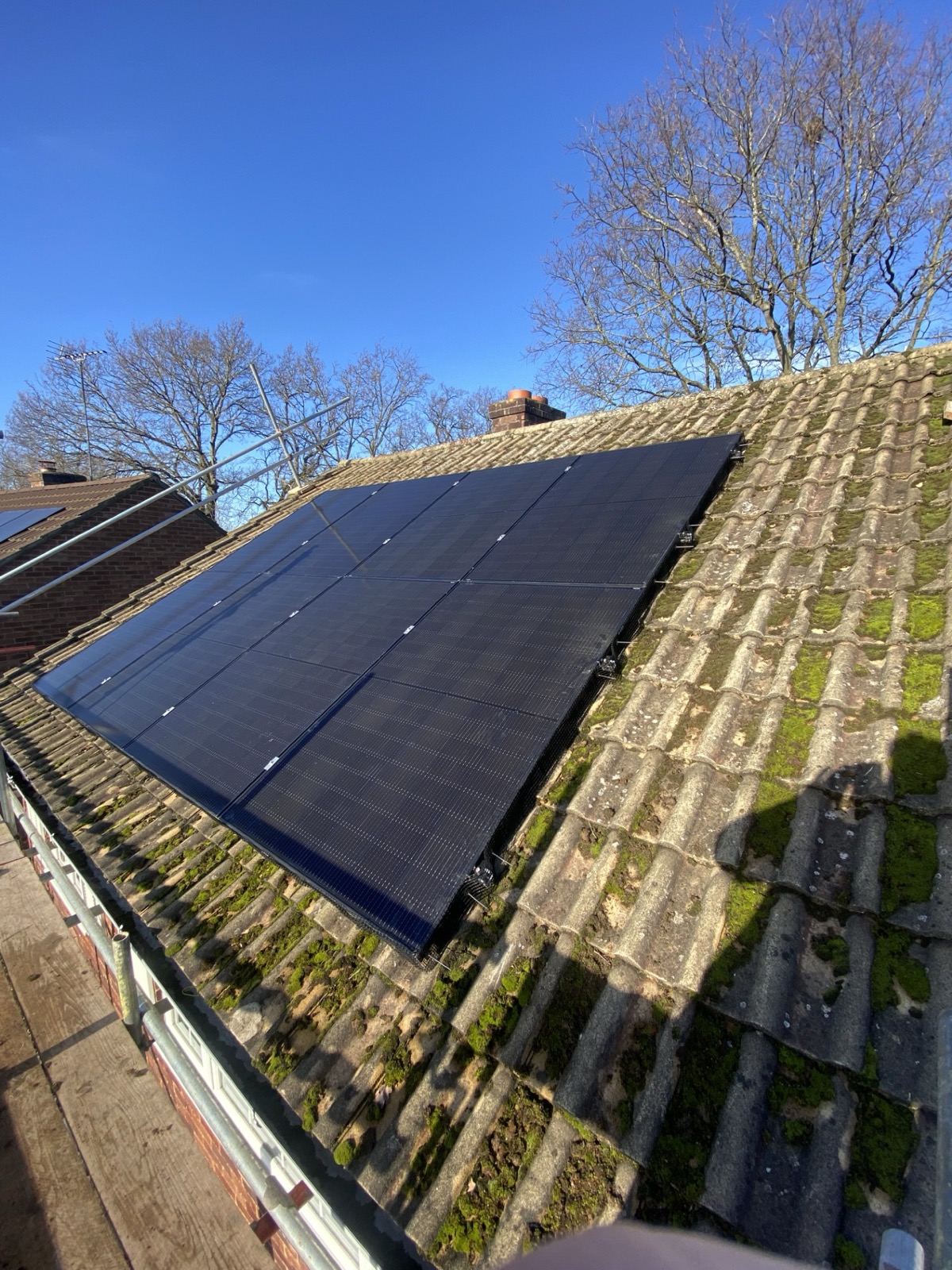 Black framed solar array on a tiled roof